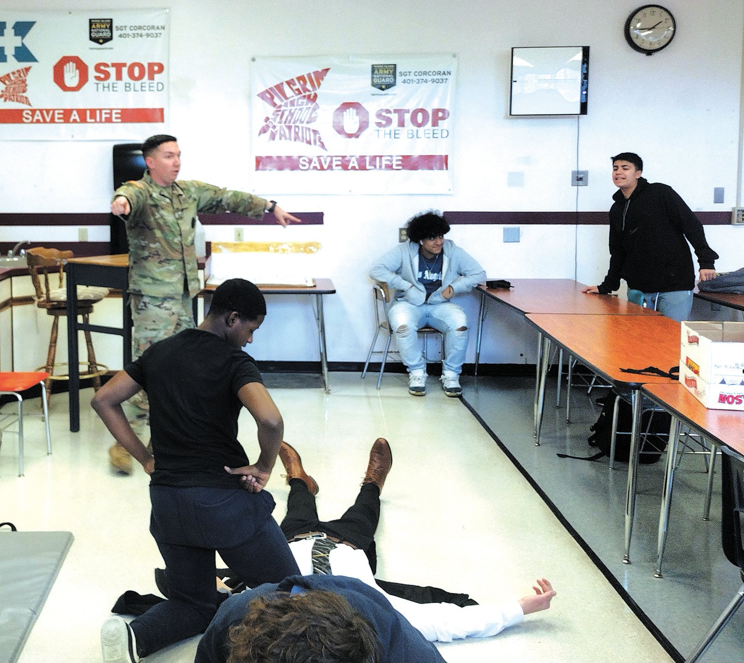 LIFESAVING TURNS: National Guard Sgt. William Naylor directs students in applying tourniquets at Pilgrim High School as part of the new Lifesaver CTE program, which prepares students to for EMT exams upon graduation. Those who pass will be able to begin work in the high-demand field. (Warwick Beacon photos)
